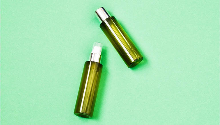 Beauty products on green background
