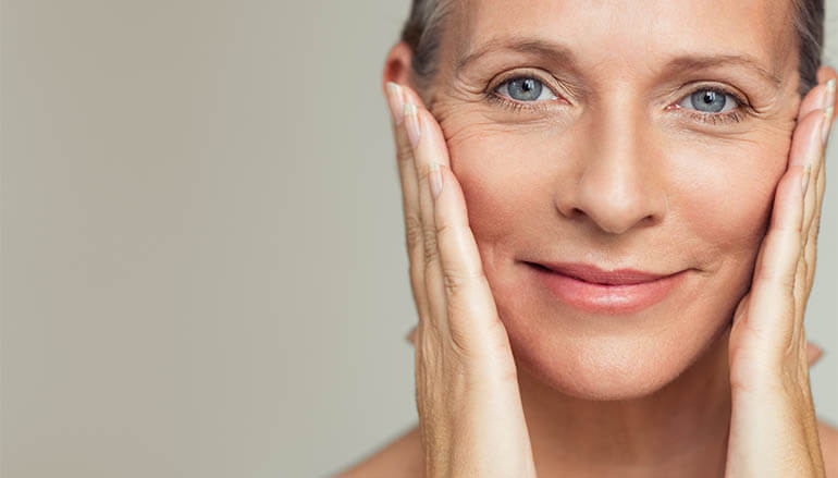 White woman with healthy skin facing camera