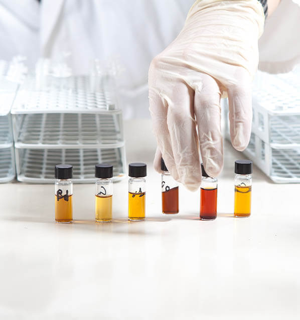 Person organizing seed oil samples in lab