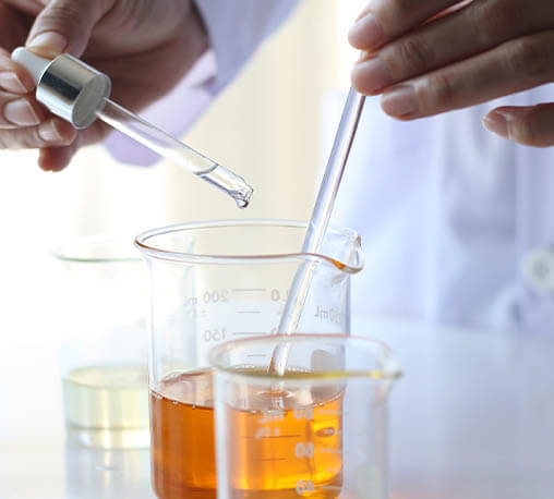 Scientist mixing oils in lab