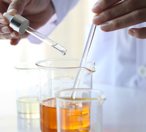 Scientist mixing oils in lab